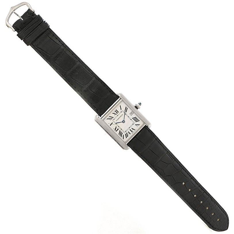 The image shows a Tank Louis model by Cartier watch laid out flat, displaying the entire strap and rectangular watch face.