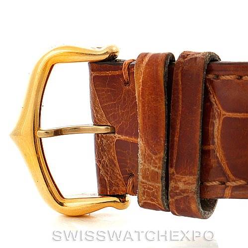 The image shows a close-up of the brown leather strap and gold buckle clasp of a Cartier Tank Louis W1529756 Men's Yellow Gold Silver Dial W1529756 Men's Yellow Gold Silver Dial watch.