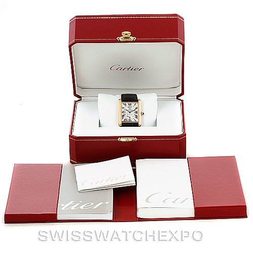The image shows a Cartier Tank Louis W1560003 Men
s Rose Gold Silver Dial W1560003 Men
s Rose Gold Silver Dial watch in its open box, accompanied by manuals and additional packaging.