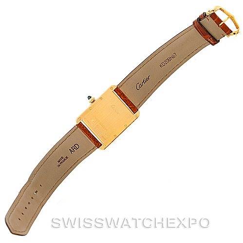 The image shows the back view of a Tank Louis watch by Cartier, displaying the strap, buckle, and case back.