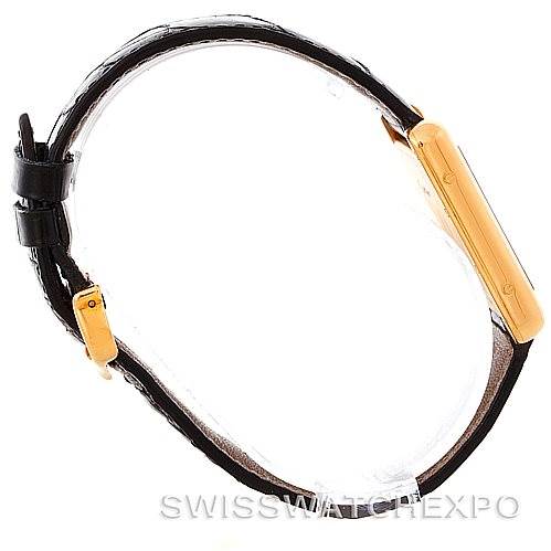 The image shows a side angle of the Tank Louis model by Cartier, highlighting the profile of the case and the leather strap.