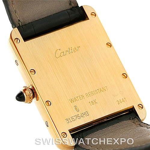 This image shows the back case of a Cartier Tank Louis W1529756 Men's Yellow Gold Silver Dial W1529756 Men's Yellow Gold Silver Dial watch with inscriptions and the crown visible.