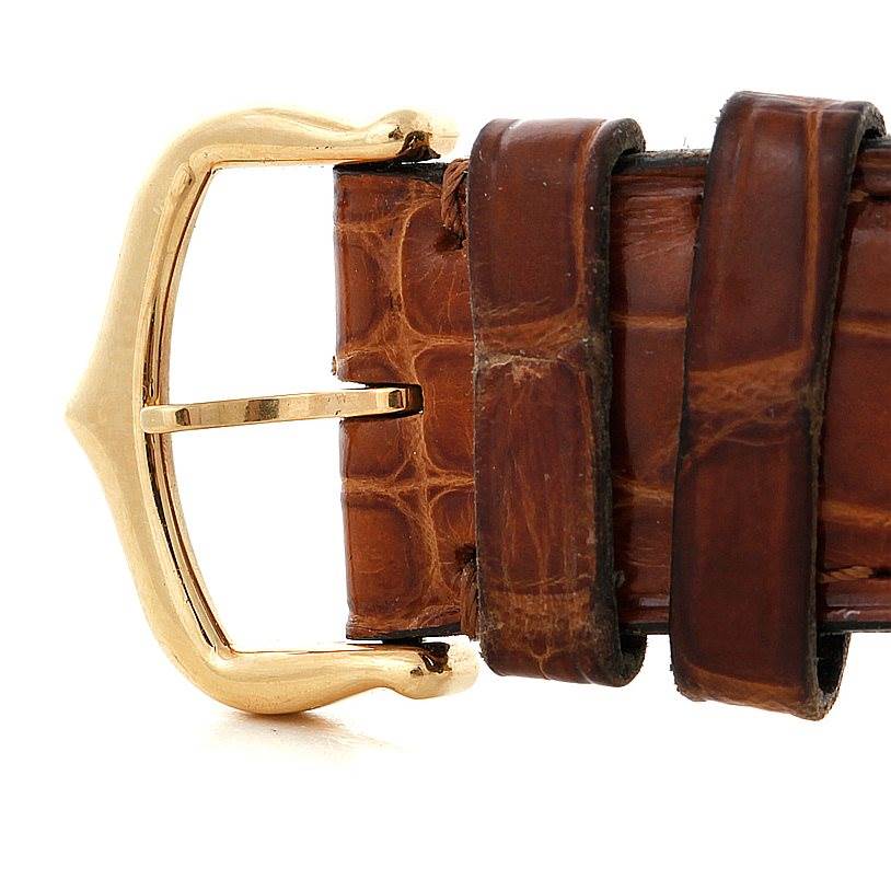 This image shows a close-up of the buckle and part of the brown leather strap of a Cartier Tank Louis W1529756 Men's Yellow Gold Silver Dial W1529756 Men's Yellow Gold Silver Dial watch.