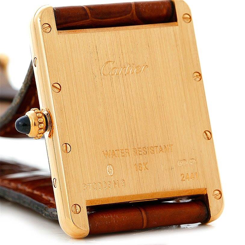 The image shows the back view of a Cartier Tank Louis W1529756 Men's Yellow Gold Silver Dial W1529756 Men's Yellow Gold Silver Dial watch, highlighting its case back with engravings and part of the strap.