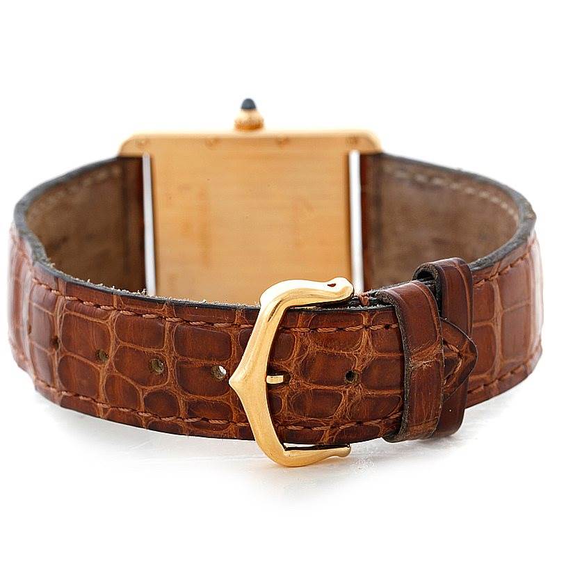 This image shows the back and brown leather strap with a gold buckle of the Tank Louis model by Cartier.