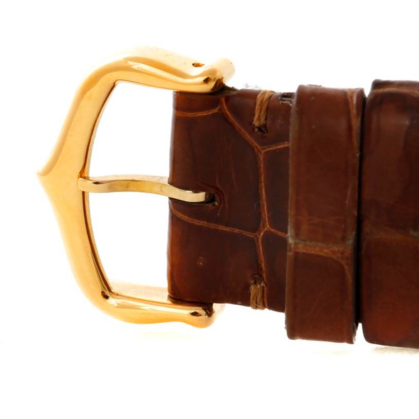 This image shows a close-up of the leather strap and golden buckle of a Cartier Tank Louis W1529756 Men's Yellow Gold Silver Dial W1529756 Men's Yellow Gold Silver Dial watch.