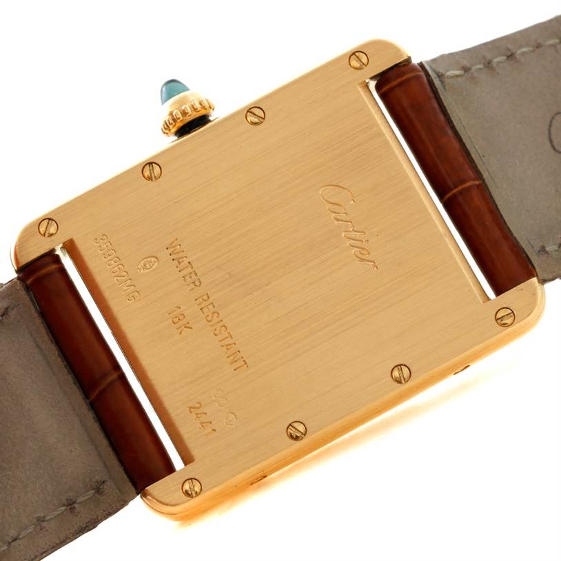 The image shows the back of the Cartier Tank Louis W1529756 Men's Yellow Gold Silver Dial W1529756 Men's Yellow Gold Silver Dial watch, highlighting the case back, markings, and part of the leather strap.