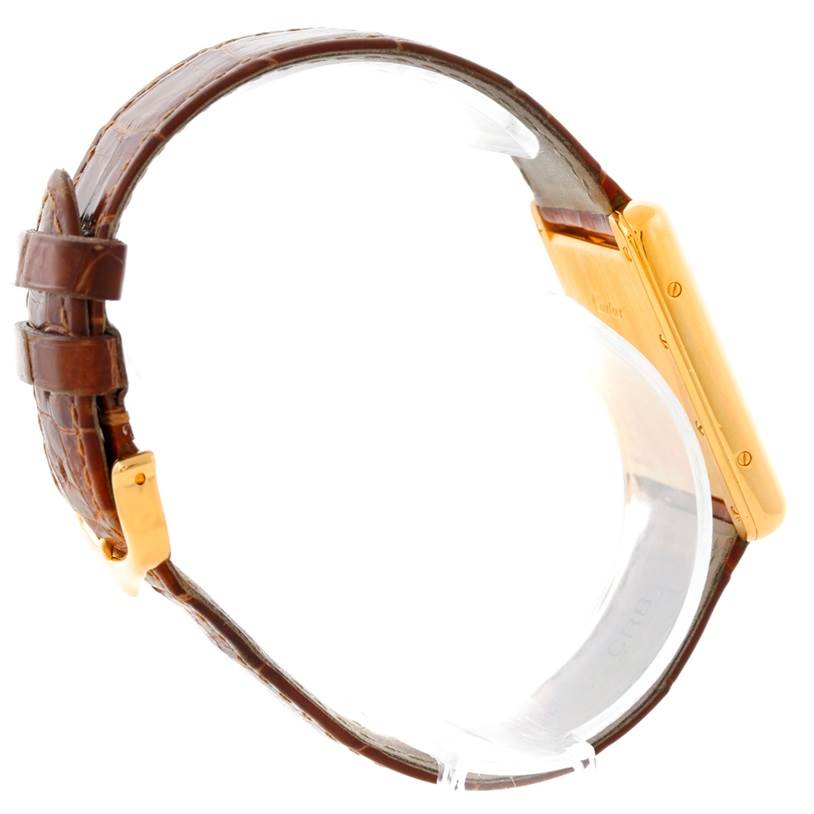 The Cartier Tank Louis W1529756 Men's Yellow Gold Silver Dial W1529756 Men's Yellow Gold Silver Dial watch is shown from a side angle, highlighting the brown leather strap and the gold case.