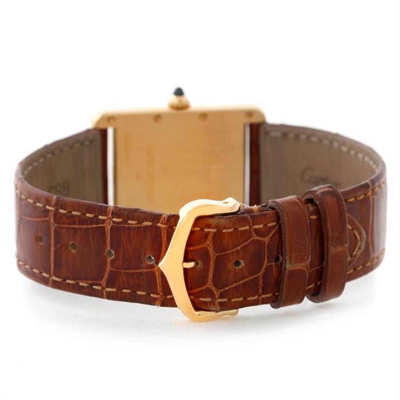 The image shows the back and strap of a Cartier Tank Louis W1529756 Men's Yellow Gold Silver Dial W1529756 Men's Yellow Gold Silver Dial watch, highlighting its brown leather band and gold buckle.