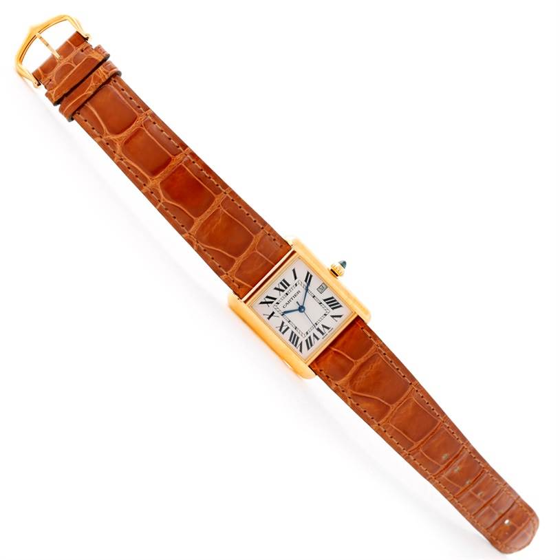 The Cartier Tank Louis W1529756 Men's Yellow Gold Silver Dial W1529756 Men's Yellow Gold Silver Dial watch is shown in a top view displaying the entire face, casing, and brown leather strap.