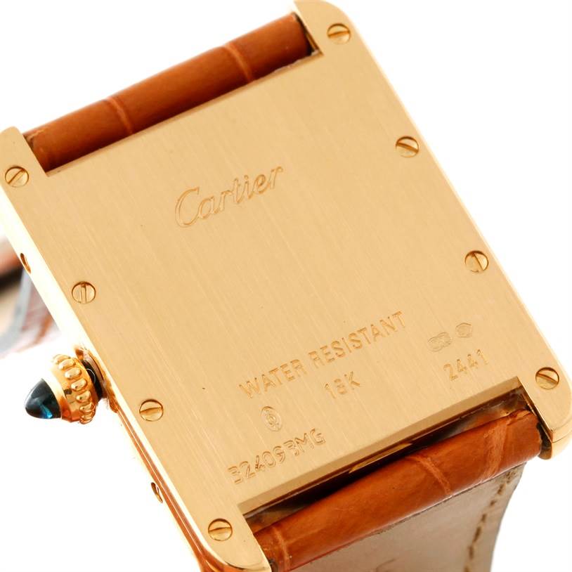 The image shows the back case and part of the strap of a Cartier Tank Louis W1529756 Men's Yellow Gold Silver Dial W1529756 Men's Yellow Gold Silver Dial watch, focusing on its inscriptions.
