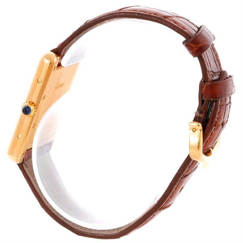 This image shows a side view of the Cartier Tank Louis W1529756 Men's Yellow Gold Silver Dial W1529756 Men's Yellow Gold Silver Dial model, highlighting its gold case, leather strap, and crown.