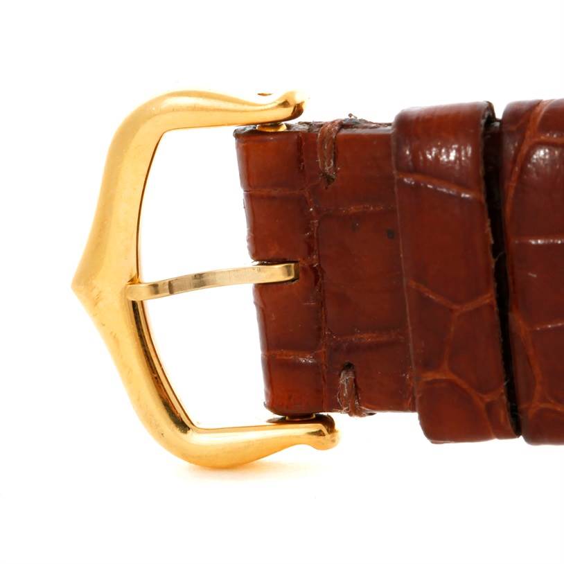 The image shows the buckle and part of the brown leather strap of a Tank Louis watch by Cartier.