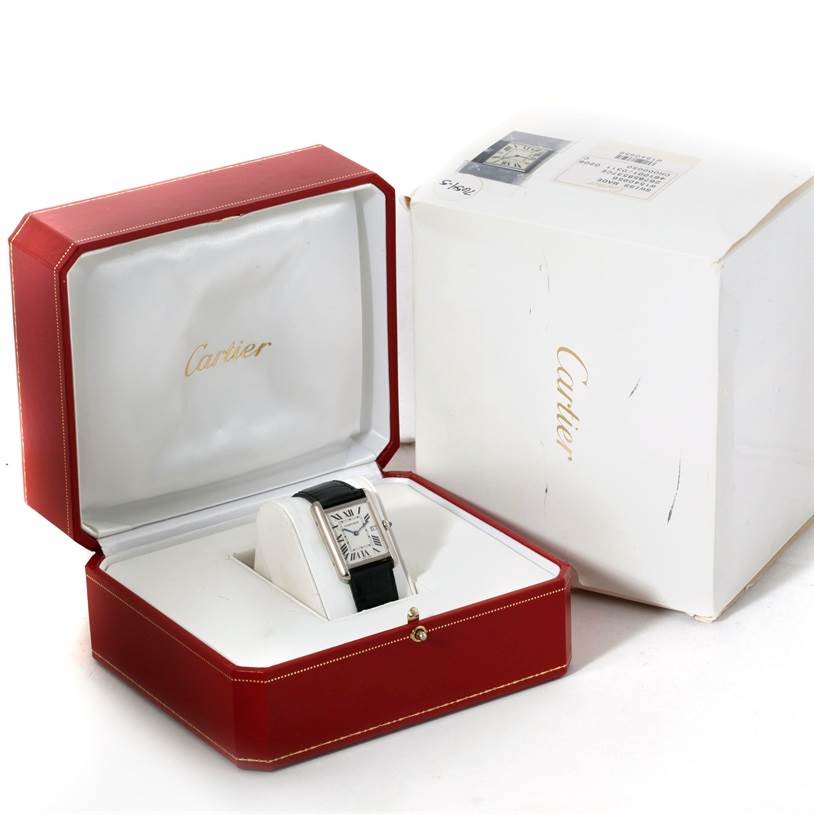This image shows the Cartier Tank Louis W1540956 Men's White Gold White Dial W1540956 Men's White Gold White Dial watch at a frontal angle inside its red and white original packaging.