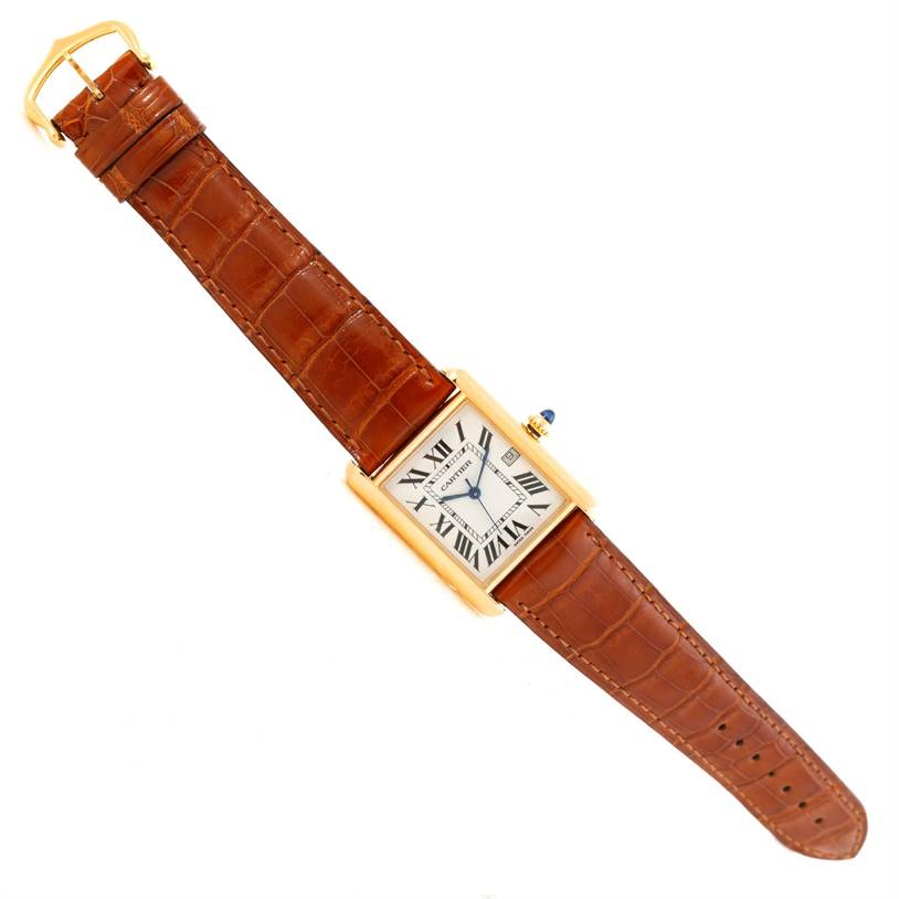 The image shows an overhead view of the Cartier Tank Louis W1529756 Men's Yellow Gold Silver Dial W1529756 Men's Yellow Gold Silver Dial watch with a brown leather strap and gold case.