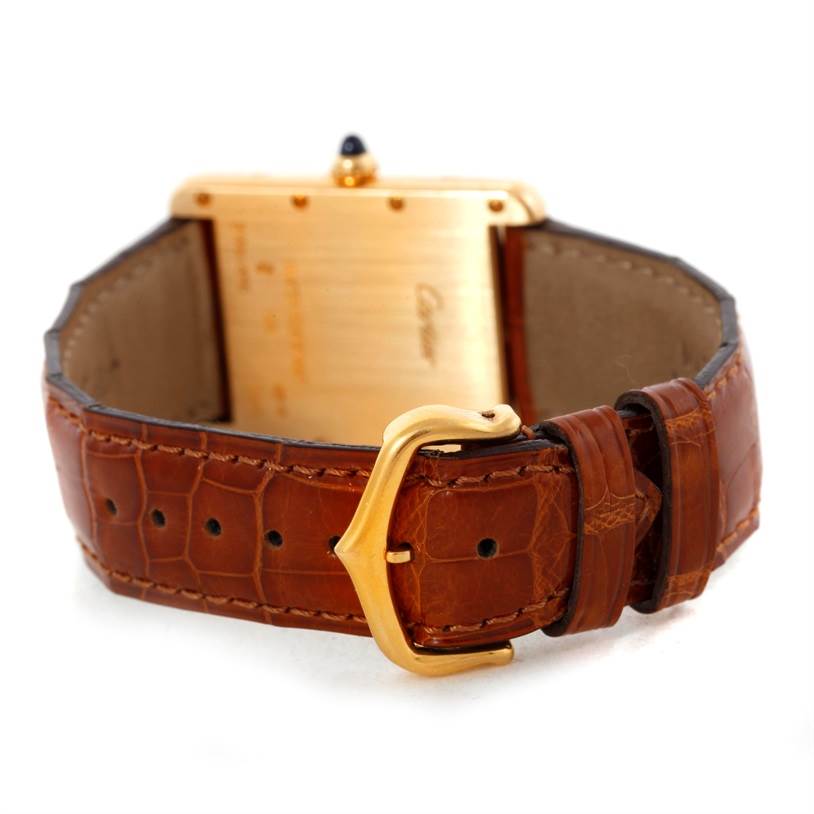 The image shows the back view of a Cartier Tank Louis W1529756 Men's Yellow Gold Silver Dial W1529756 Men's Yellow Gold Silver Dial watch, highlighting its brown leather strap and gold buckle.