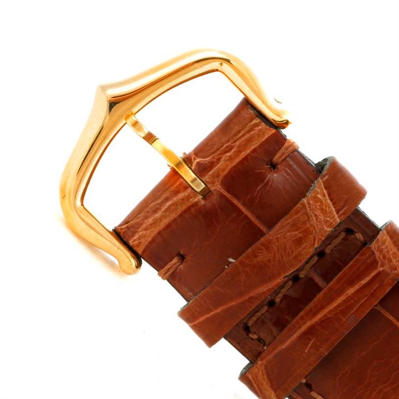 The image shows a brown leather strap with a gold buckle for a Cartier Tank Louis W1529756 Men's Yellow Gold Silver Dial W1529756 Men's Yellow Gold Silver Dial watch from a close-up angle.
