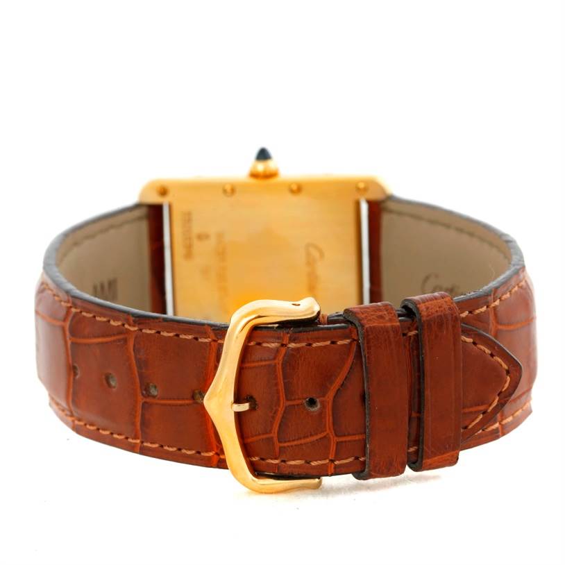 This image shows the back of a Cartier Tank Louis W1529756 Men
s Silver Dial W1529756 Men
s Silver Dial watch focusing on the brown leather strap and gold buckle.