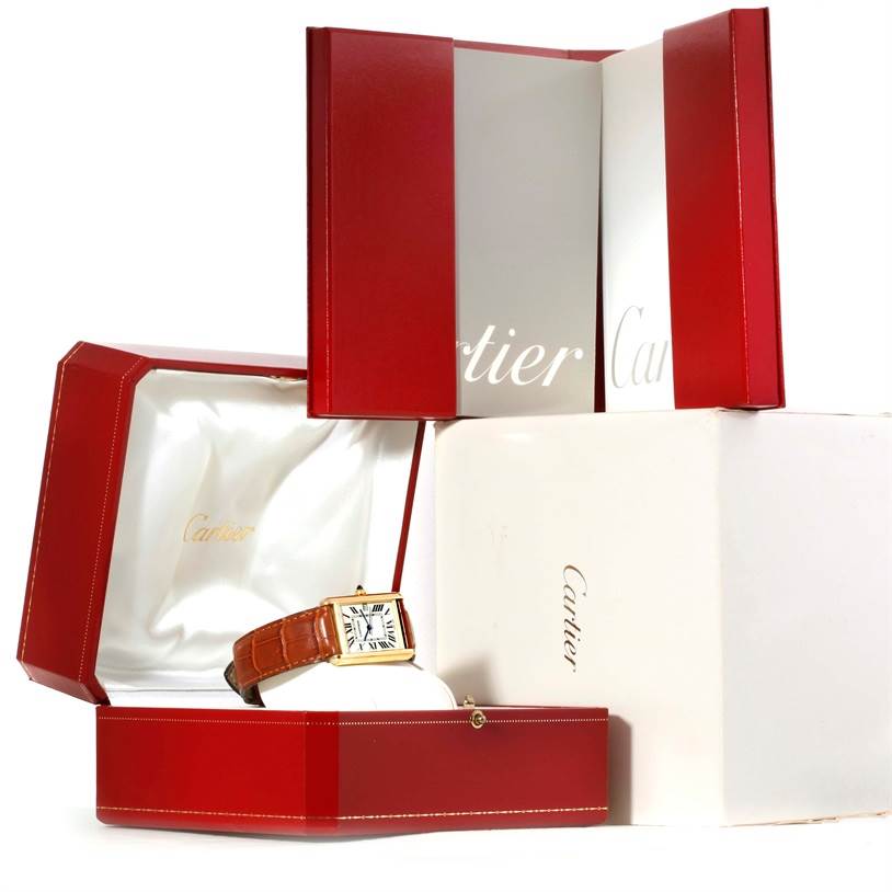 The image shows the Cartier Tank Louis W1529756 Men
s Silver Dial W1529756 Men
s Silver Dial watch in its red presentation box, with additional packaging visible in the background.