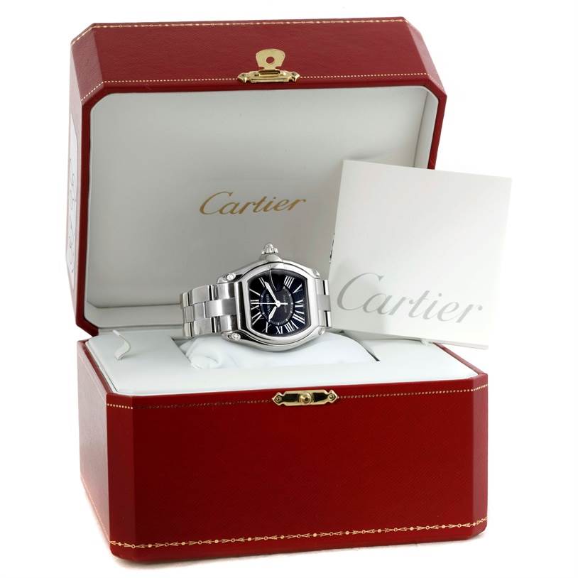The Cartier Roadster W62041V3 Men
s Stainless Steel Black Dial W62041V3 Men
s Stainless Steel Black Dial watch is displayed inside its red and white box, with a presentation card leaning against it.