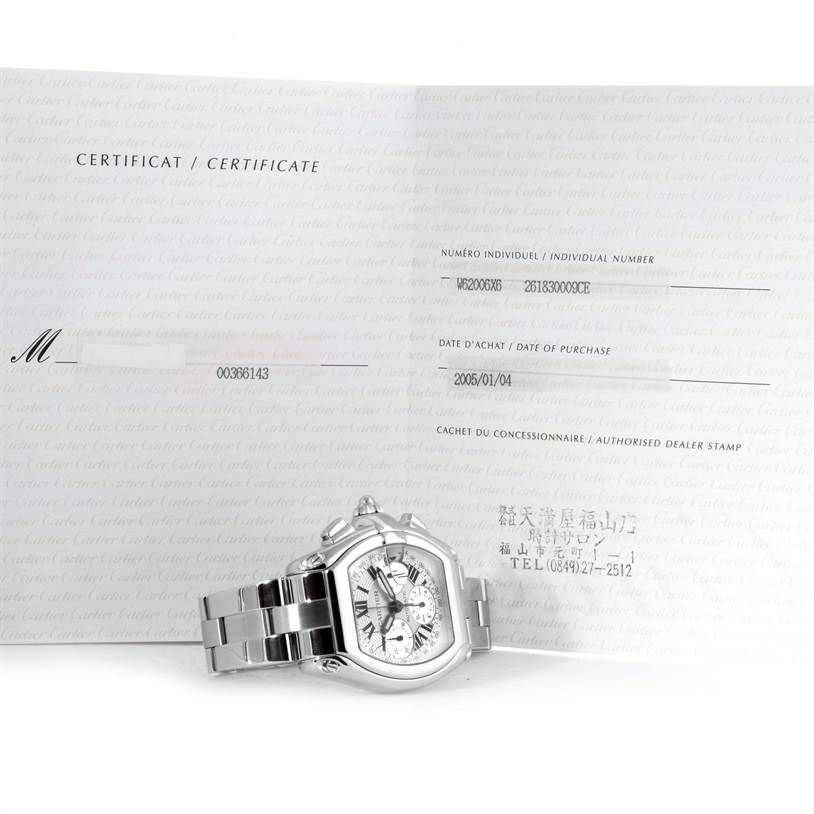 The Cartier Roadster W62006X6 Men's Stainless Steel Silver Dial W62006X6 Men's Stainless Steel Silver Dial watch is shown at a slight angle with its certificate of authenticity in the background.