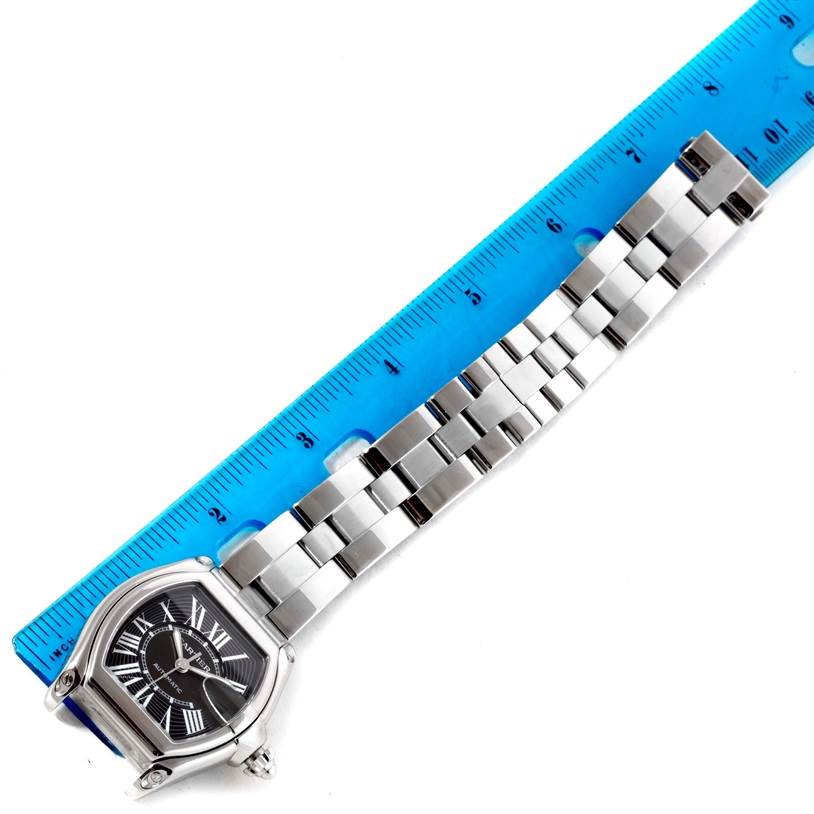 The Cartier Roadster W62041V3 Men's Stainless Steel Black Dial W62041V3 Men's Stainless Steel Black Dial watch is shown from an aerial view with the face and stainless steel bracelet visible, measured against a ruler.