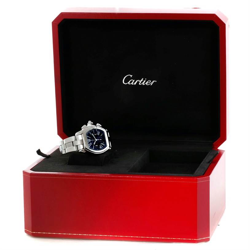 The Cartier Roadster W62020X6 Men's Stainless Steel Black Dial W62020X6 Men's Stainless Steel Black Dial watch is displayed in an open red and black Cartier box, showing its face and part of its bracelet.