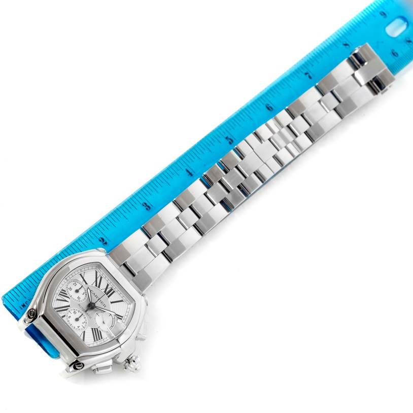 The Cartier Roadster W62019X6 Men's Stainless Steel Silver Dial W62019X6 Men's Stainless Steel Silver Dial watch is shown diagonally, featuring the case, dial, bracelet, and clasp, with a ruler for scale.