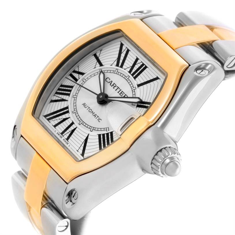 The image shows a close-up view of a Cartier Roadster W62031Y4 Men's Steel and Gold (two tone) Silver Dial W62031Y4 Men's Steel and Gold (two tone) Silver Dial watch face, showcasing its bezel, dial, and part of the bracelet.