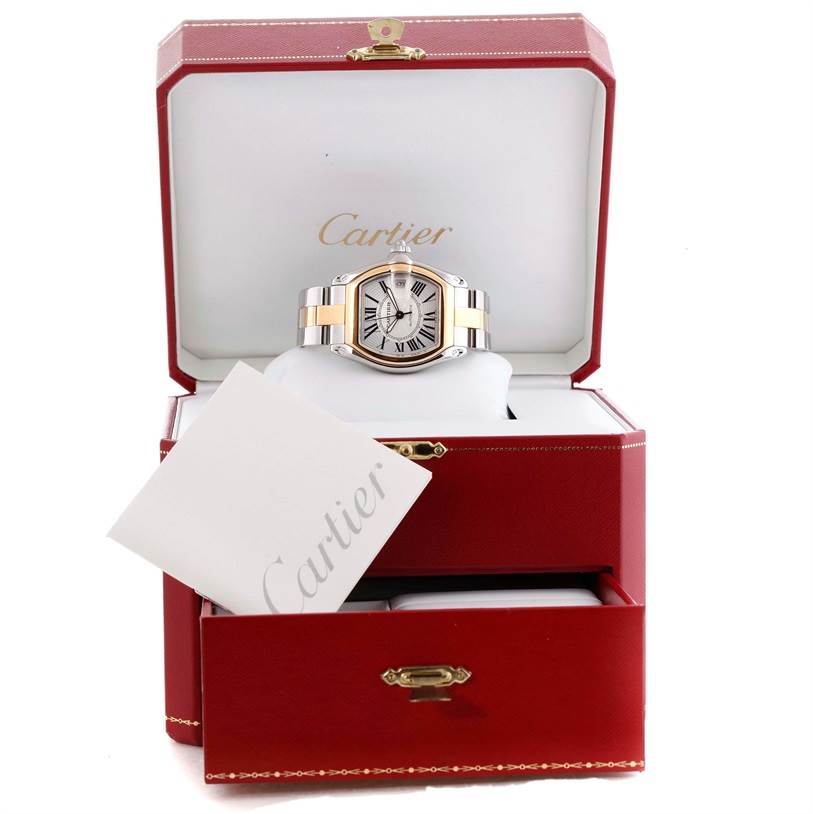 The Cartier Roadster W62031Y4 Men's Steel and Gold (two tone) Silver Dial W62031Y4 Men's Steel and Gold (two tone) Silver Dial watch is displayed front-facing inside a red Cartier box with a visible card and a drawer below.