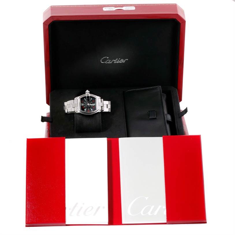 The Cartier Roadster W62002V3 Men's Stainless Steel Black Dial W62002V3 Men's Stainless Steel Black Dial watch is shown in its open box, alongside booklets and an additional pouch.