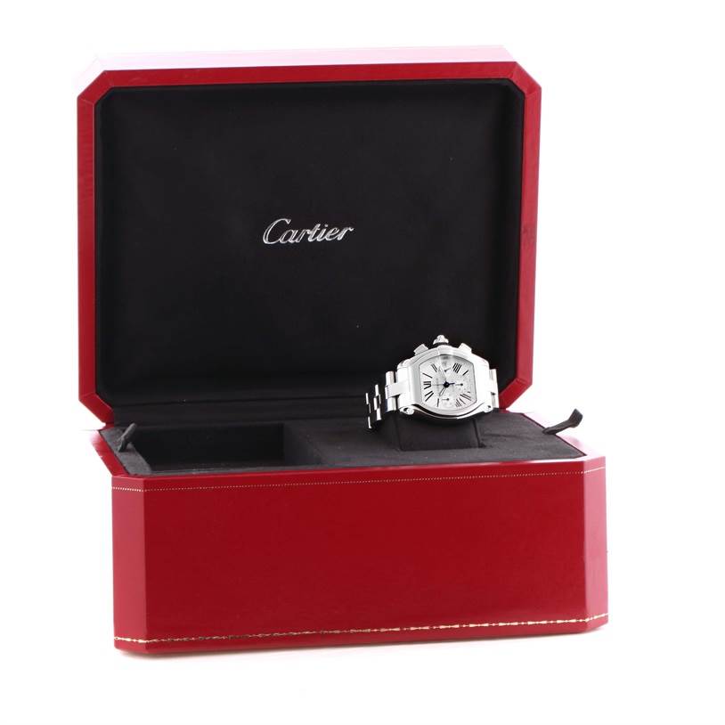 The Cartier Roadster W62019X6 Men's Stainless Steel Silver Dial W62019X6 Men's Stainless Steel Silver Dial watch is displayed in an open red Cartier box, showing the face and part of the bracelet.