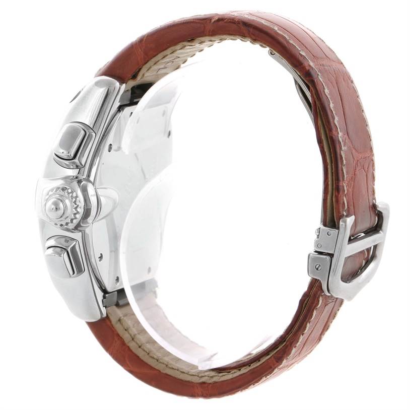The image shows a side view of a Cartier Roadster W62019X6 Men's Stainless Steel Silver Dial W62019X6 Men's Stainless Steel Silver Dial watch, highlighting the crown, pushers, and brown leather strap with its buckle.