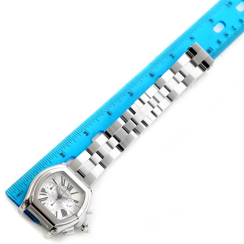 The Cartier Roadster W62019X6 Men's Stainless Steel Silver Dial W62019X6 Men's Stainless Steel Silver Dial watch is shown at an overhead angle, displaying the face, bezel, and a portion of the metal bracelet.