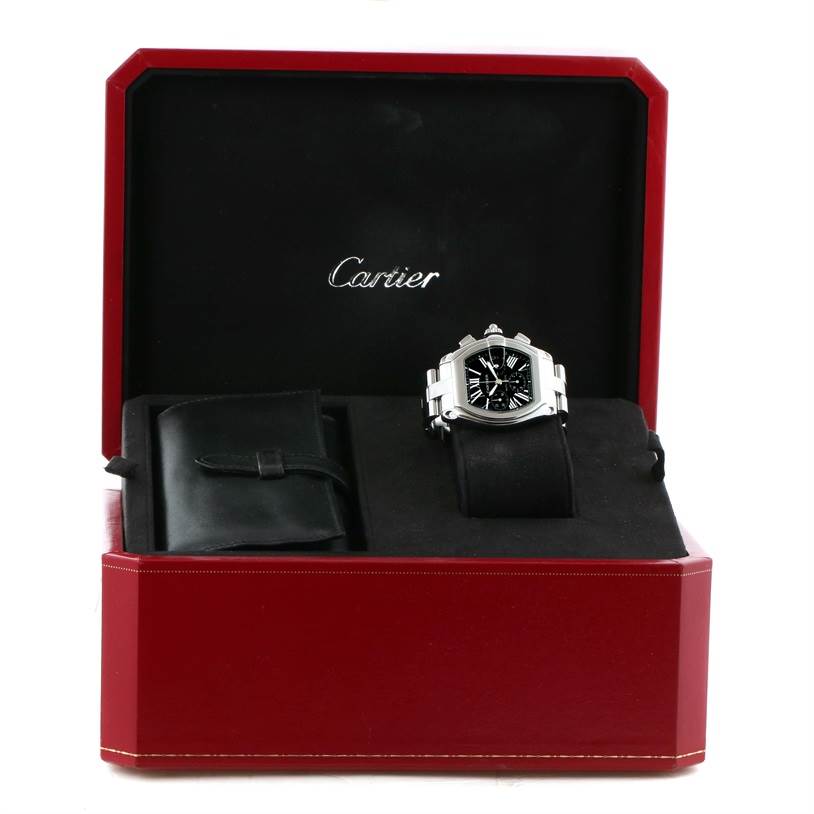 This image shows a Cartier Roadster W62020X6 Men's Stainless Steel Black Dial W62020X6 Men's Stainless Steel Black Dial watch in its open case, displayed frontally with visible black dial and silver bracelet.
