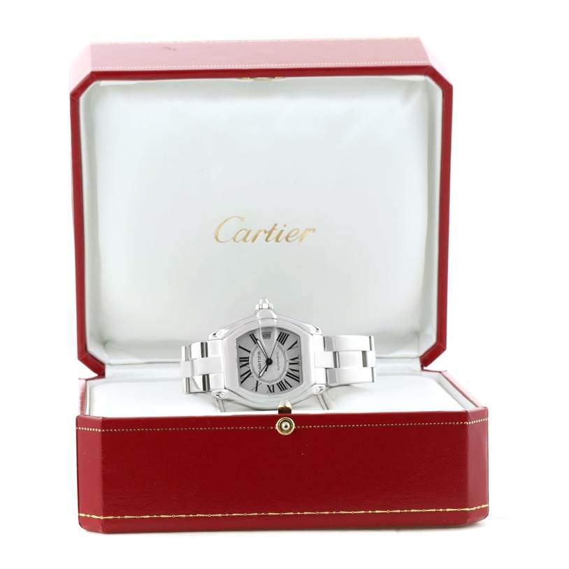 The Cartier Roadster W62025V3 Men's Stainless Steel Silver Dial W62025V3 Men's Stainless Steel Silver Dial watch is displayed front and center inside its open red and white branded case.