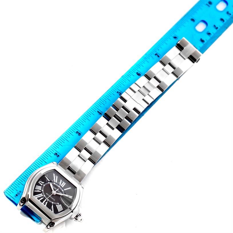 This image shows the face and bracelet of a Cartier Roadster W62041V3 Men's Stainless Steel Black Dial W62041V3 Men's Stainless Steel Black Dial watch beside a ruler for measurement.