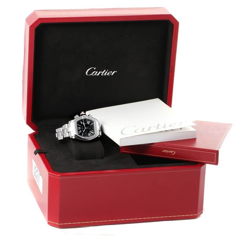 The Cartier Roadster W62020X6 Men's Stainless Steel Black Dial W62020X6 Men's Stainless Steel Black Dial watch is displayed in its box with accompanying booklets.