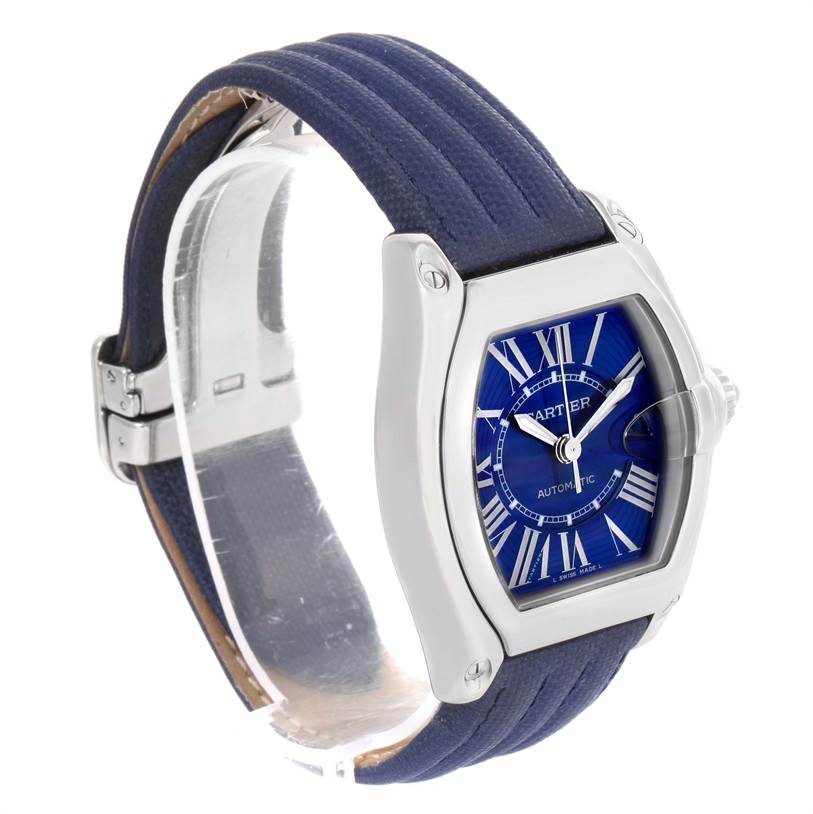 The Cartier Roadster W62048V3 Men's Stainless Steel Blue Dial W62048V3 Men's Stainless Steel Blue Dial watch is shown at a three-quarters angle, displaying its blue dial, Roman numerals, and blue strap.