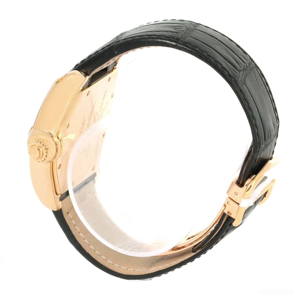 The Cartier Roadster W62005V2 Men's Yellow Gold Silver Dial W62005V2 Men's Yellow Gold Silver Dial watch is shown from a side angle, highlighting its crown, case back, and leather strap.