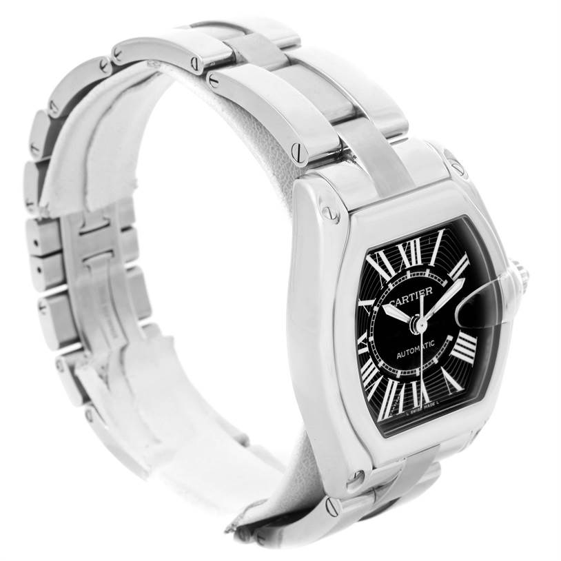 The image shows a Cartier Roadster W62041V3 Men
s Stainless Steel Black Dial W62041V3 Men
s Stainless Steel Black Dial watch at a slight angle, highlighting the face, Roman numerals, and metal bracelet.
