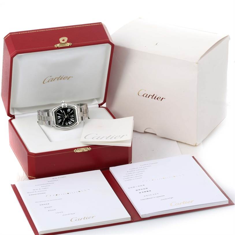 The Cartier Roadster W62041V3 Men
s Stainless Steel Black Dial W62041V3 Men
s Stainless Steel Black Dial watch is shown at a front angle in its open red box, with accompanying booklets and packaging visible.