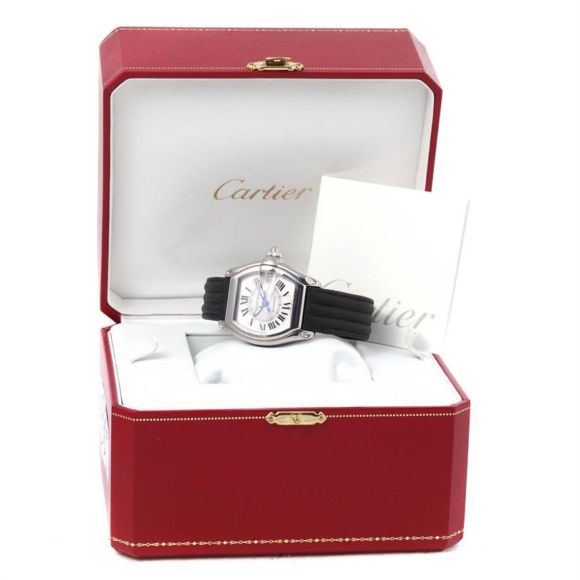 The Cartier Roadster W62000V3 Men's Stainless Steel Silver Dial W62000V3 Men's Stainless Steel Silver Dial watch is shown from a frontal angle inside its red Cartier box with accompanying documents.