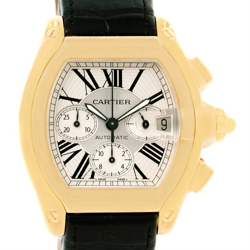 The image shows a Cartier Roadster W62021Y2 Men's Yellow Gold Silver Dial W62021Y2 Men's Yellow Gold Silver Dial watch from a front angle, displaying its face, dials, and part of the strap.