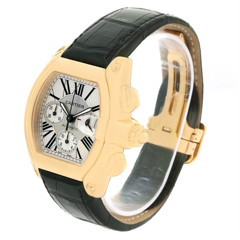 The image shows a side angle of the Cartier Roadster W62021Y2 Men's Yellow Gold Silver Dial W62021Y2 Men's Yellow Gold Silver Dial watch, highlighting its dial, crown, pushers, and black strap.