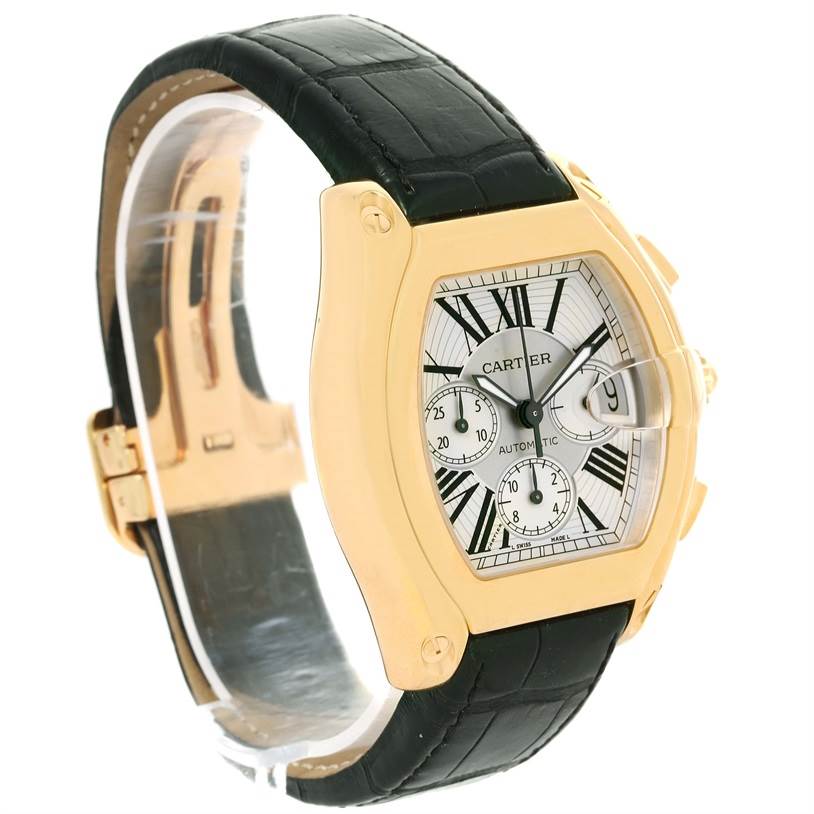 The Cartier Roadster W62021Y2 Men's Yellow Gold Silver Dial W62021Y2 Men's Yellow Gold Silver Dial watch is shown from a three-quarter angle, highlighting the face, case, and black leather strap.