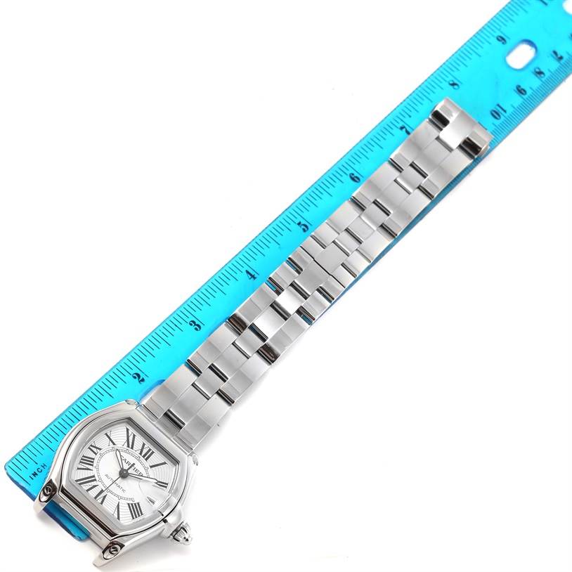 The Cartier Roadster W62025V3 Men's Stainless Steel Silver Dial W62025V3 Men's Stainless Steel Silver Dial watch is shown from a top-down angle with its face and full band aligned with a ruler.