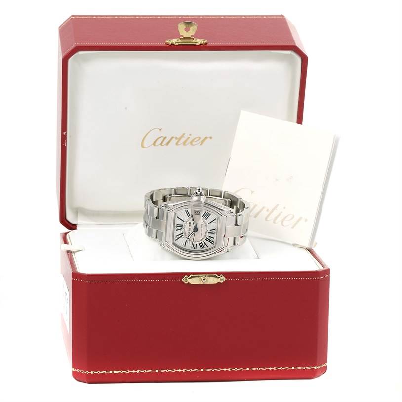 The Cartier Roadster W62025V3 Men's Stainless Steel Silver Dial W62025V3 Men's Stainless Steel Silver Dial watch is displayed with its case and documents in an open red Cartier box.