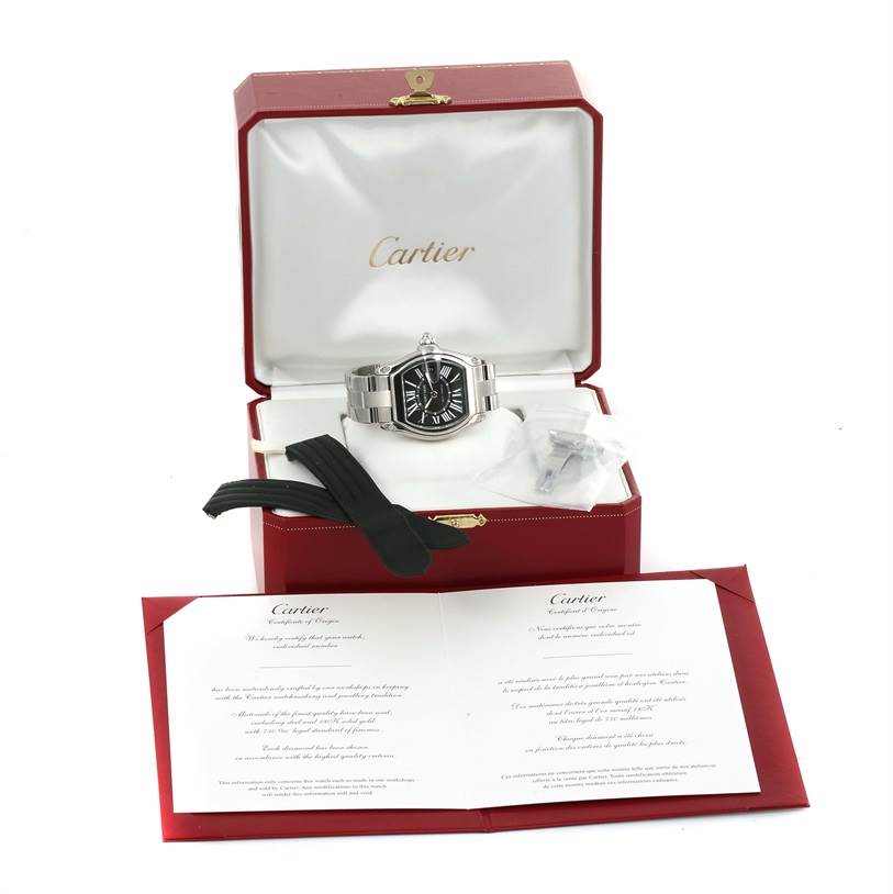 The Cartier Roadster W62041V3 Men
s Stainless Steel Black Dial W62041V3 Men
s Stainless Steel Black Dial watch is displayed in an open box with booklets and extra black straps visible.