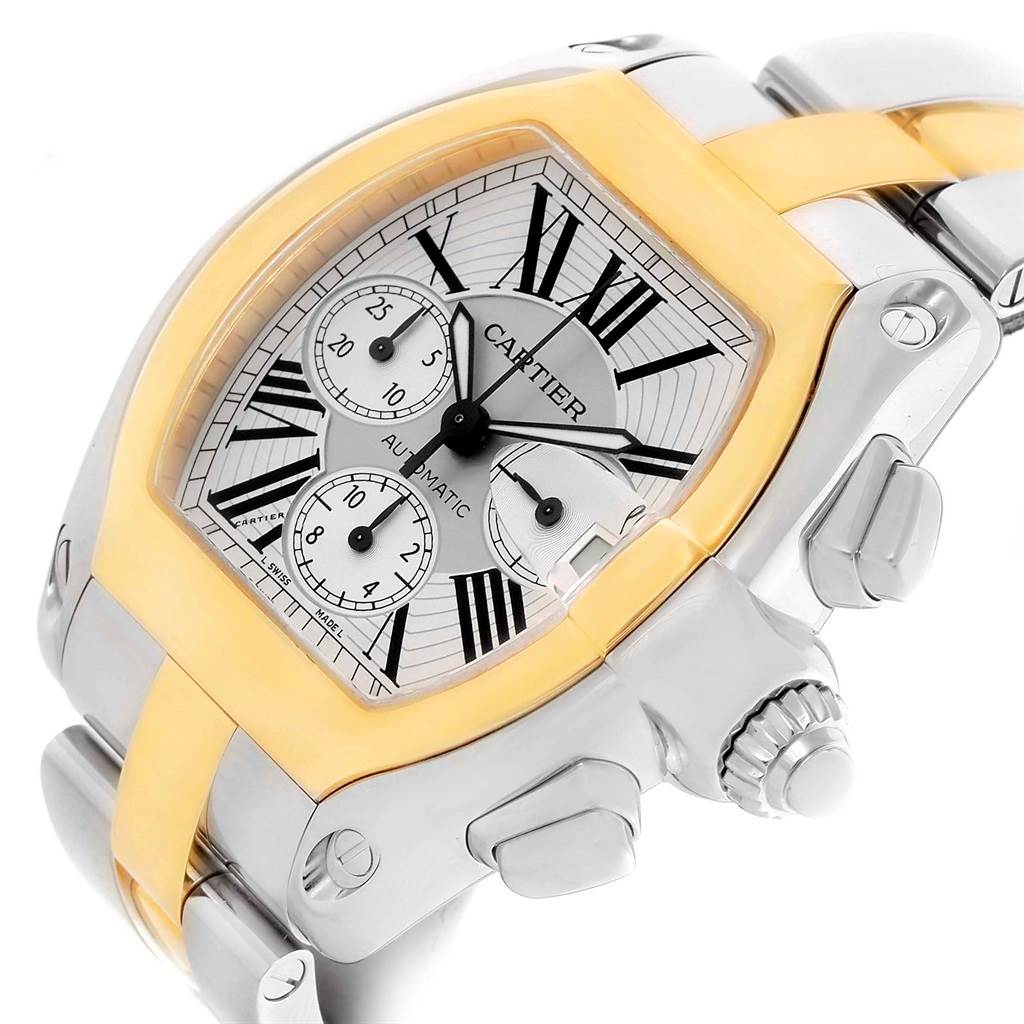 The image shows a close-up angled view of the Cartier Roadster W62027Z1 Men's Steel and Gold (two tone) Silver Dial W62027Z1 Men's Steel and Gold (two tone) Silver Dial watch, highlighting its dial, crown, and two-tone bracelet.